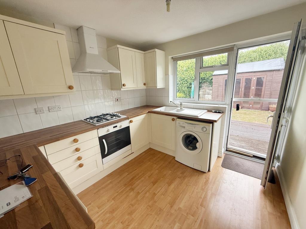 Lot: 134 - SEMI-DETACHED BUNGALOW FOR IMPROVEMENT - Kitchen with door to the rear garden
